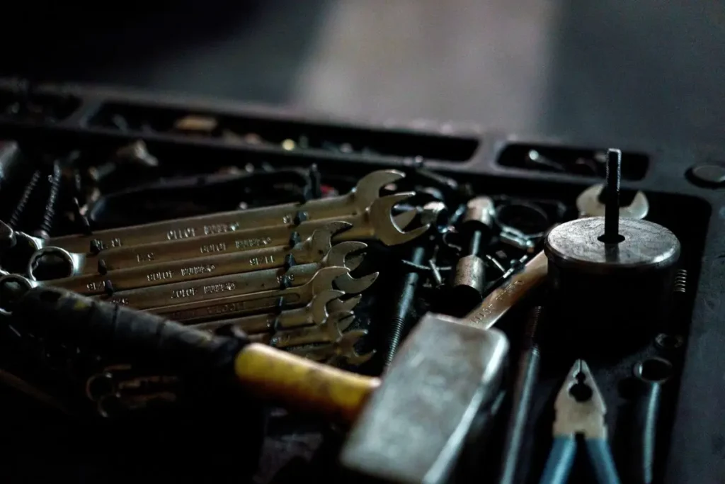 A set of wrenches and hand tools arranged in a toolbox