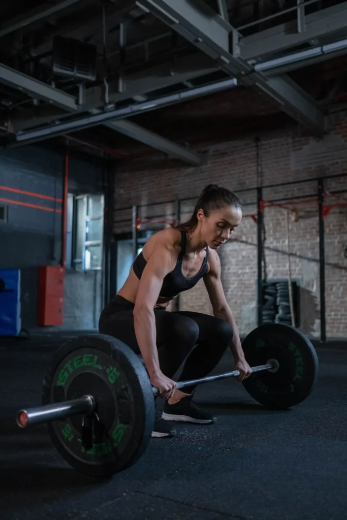 A focused athlete lifting a barbell during a training session
